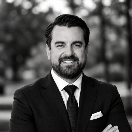 Timothy P. Doud, Managing Partner and Financial Advisor, in a black-and-white portrait wearing a suit and tie.